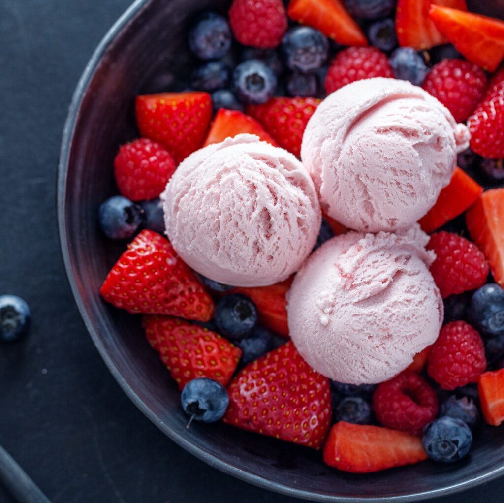 Fruity ice cream scoops on plate